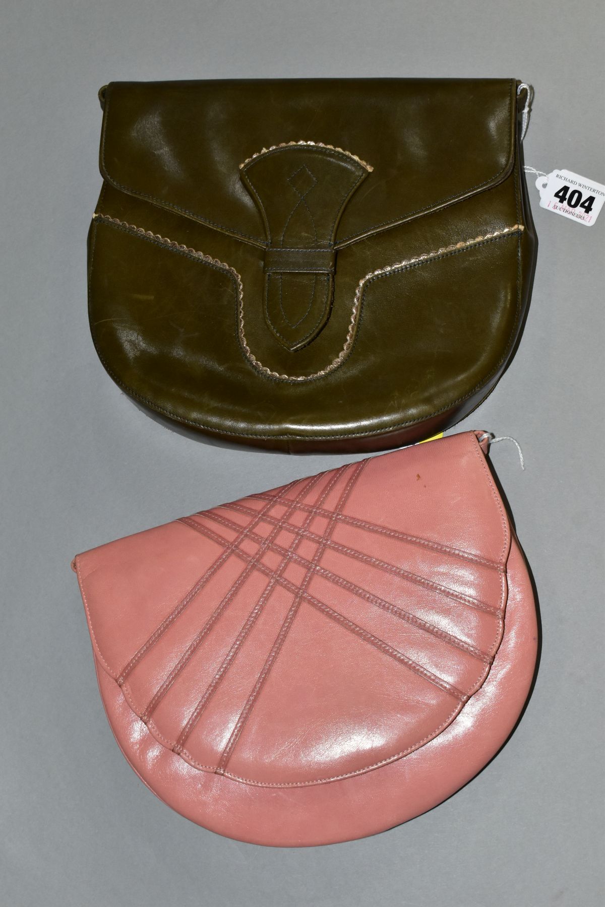 TWO CHARLES JOURDAN LEATHER HANDBAGS, one in pink with 55cm shoulder strap, the other in green