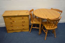 A MODERN PINE CIRCULAR KITCHEN TABLE, diameter 90cm x height 75cm, three chairs and a pine chest