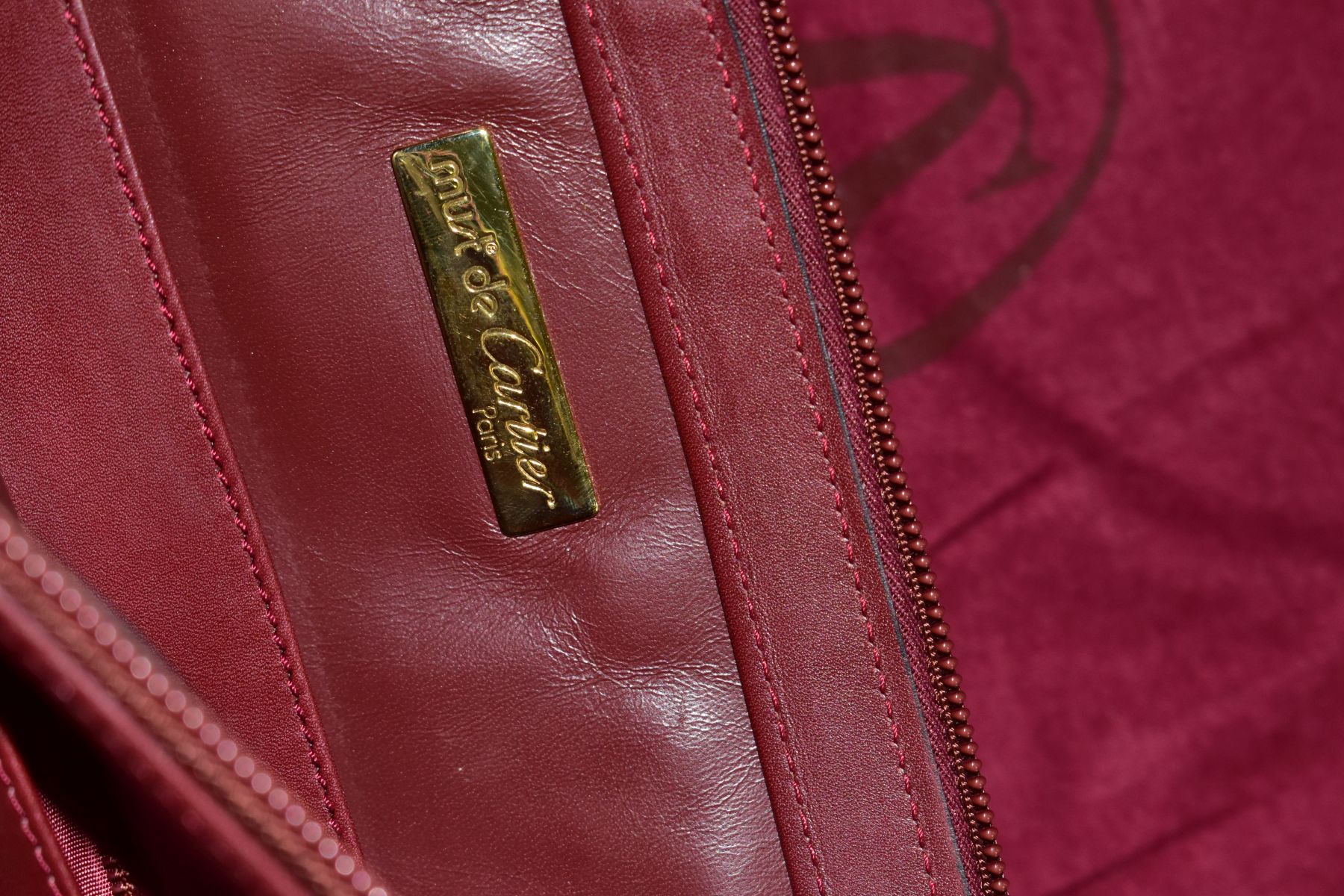 A CARTIER RED LEATHER SOFT BRIEFCASE, case has indentations to the exterior, width 41cm x height - Image 5 of 5