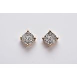 A PAIR OF YELLOW METAL DIAMOND CLUSTER EARRINGS, each of a circular design set with brilliant cut