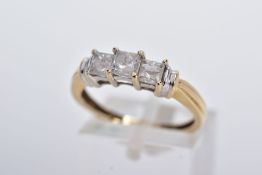 A 14CT GOLD THREE STONE DIAMOND RING, designed with a row of three claw set princess cut diamonds,