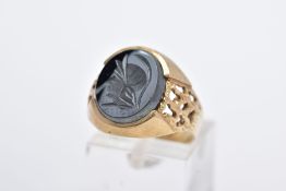 A GENTS 9CT GOLD HEMATITE SIGNET RING, designed with an oval hematite intaglio depicting a gentleman