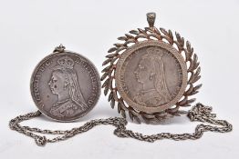 TWO MOUNTED VICTORIAN CROWN COINS, each depicting Queen Victoria to one side and St. George and