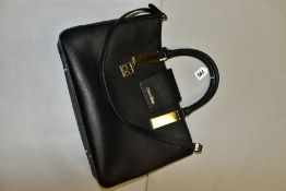 A CALVIN KLEIN BLACK LEATHER HANDBAG, fitted with detachable shoulder strap, carry handles, over the