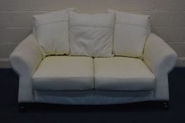 A CREAM LEATHER TWO SEATER SETTEE, width 173cm