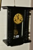A LATE 19TH CENTURY GERMAN WALL CLOCK, ebonised case with half columns flanking the glazed door, the