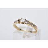 A 14CT GOLD DIAMOND RING, designed as a half eternity ring set with three raised princess cut