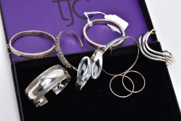 A COLLECTION OF SILVER AND WHITE METAL BANGLES AND A PAIR OF HOOP EARRINGS, to include a silver