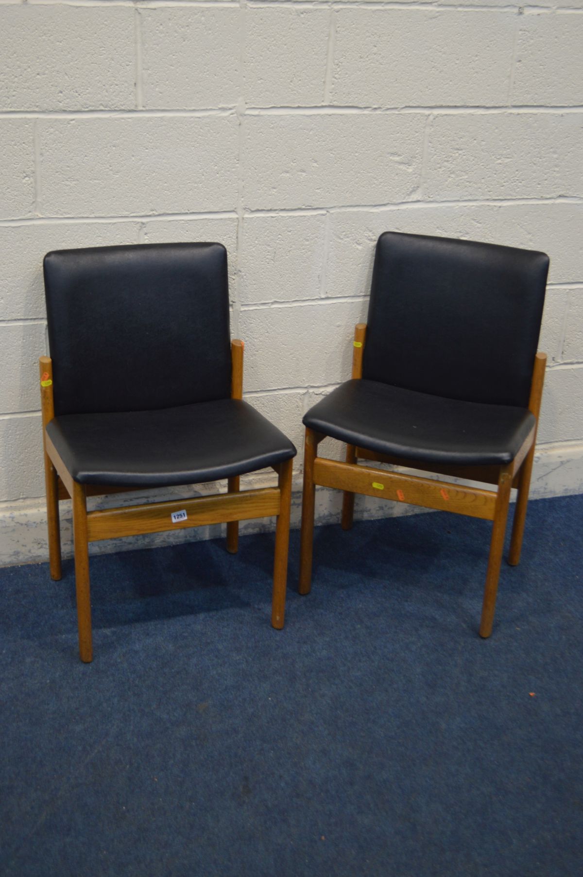 A PAIR OF MID TO LATE 20TH CENTURY OAK FRAMED AND BLACK LEATHERETTE CHAIRS