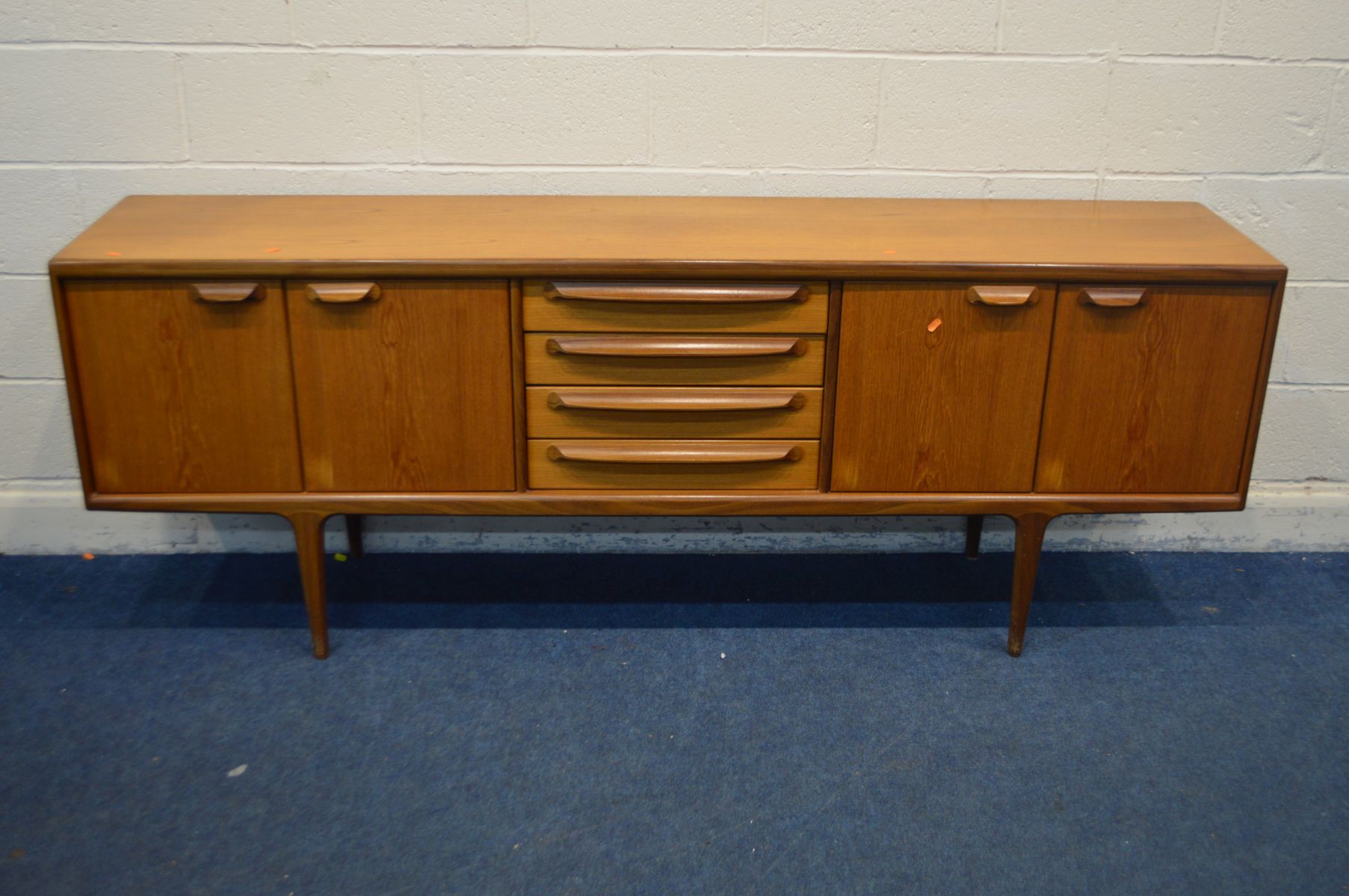 JOHN HERBERT FOR YOUNGER, A 1960'S TEAK 7FT SIDEBOARD, with double cupboard doors flanking four