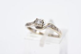 A 9CT DIAMOND RING, designed with a central round brilliant cut diamond within a square surround,