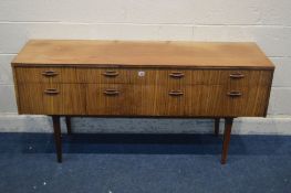 A MID TO LATE 20TH CENTYURY AFROMOSIA SIDEBOARD/CHEST OF SIX ASSORTED DRAWERS, on square tapering