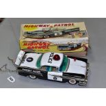 A BOXED OKUMA BATTERY OPERATED TINPLATE OLDSMOBILE HIGHWAY PATROL CAR, lithographed black and