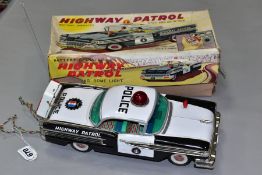 A BOXED OKUMA BATTERY OPERATED TINPLATE OLDSMOBILE HIGHWAY PATROL CAR, lithographed black and