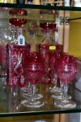 A PAIR OF 20TH CENTURY CRANBERRY AND CLEAR GLASS SQUARE DECANTERS, one stopper broken, together with