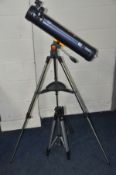 A CELESTRON ASTROMASTER LT76AZ TELESCOPE with two eye pieces, on a folding tripod, together with a