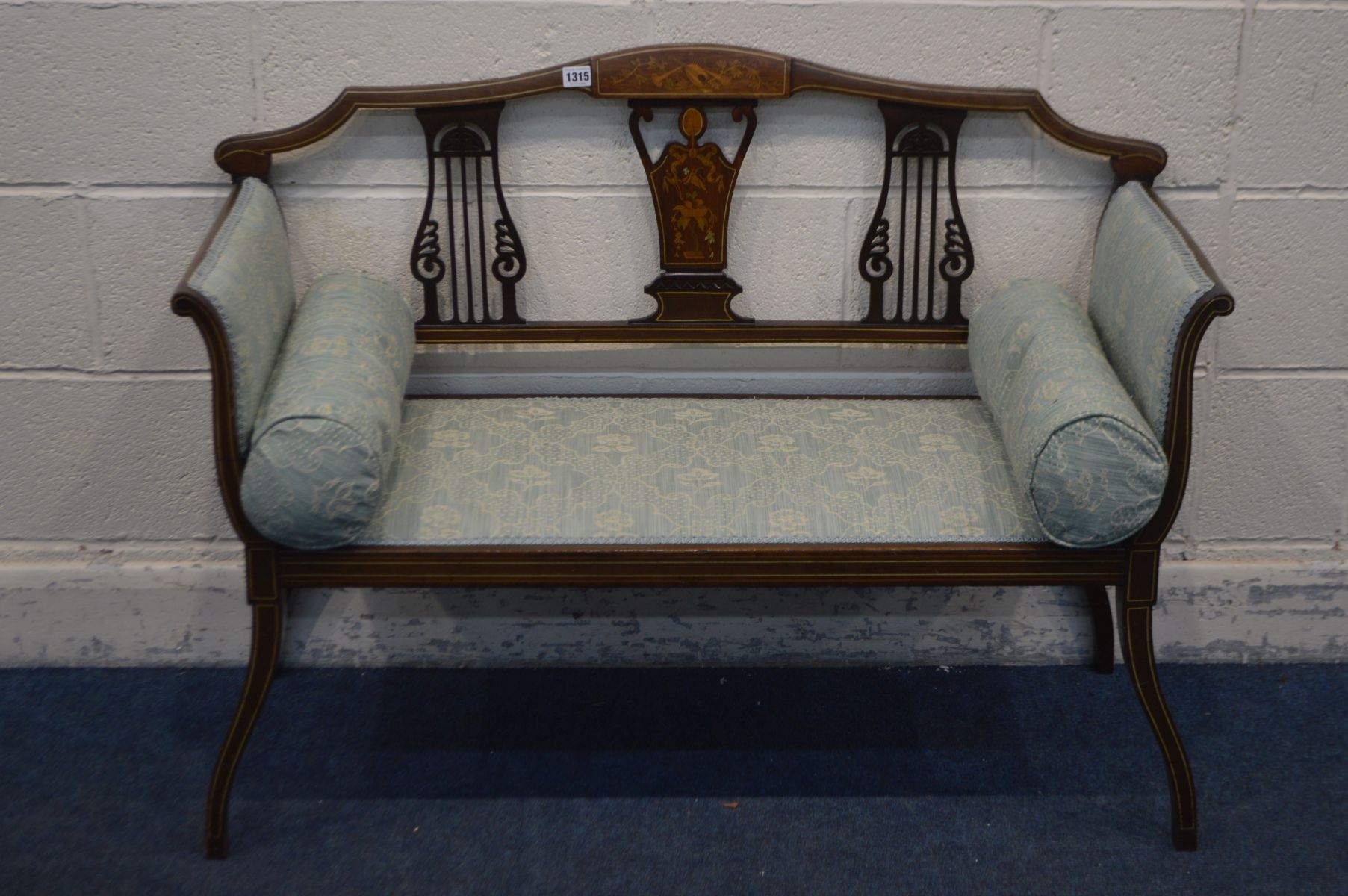 AN EDWARDIAN MAHOGANY AND MARQUETRY INLAID TWO SEATER SOFA, with green upholstery, and two side