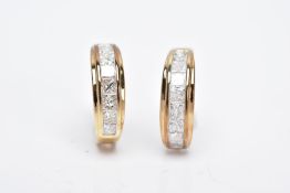 A PAIR OF 9CT GOLD DIAMOND HUGGIE EARRINGS, each designed with a row of channel set princess cut