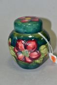 A MOORCROFT POTTERY GINGER JAR AND COVER, green ground decorated in a red/blue clematis pattern, the