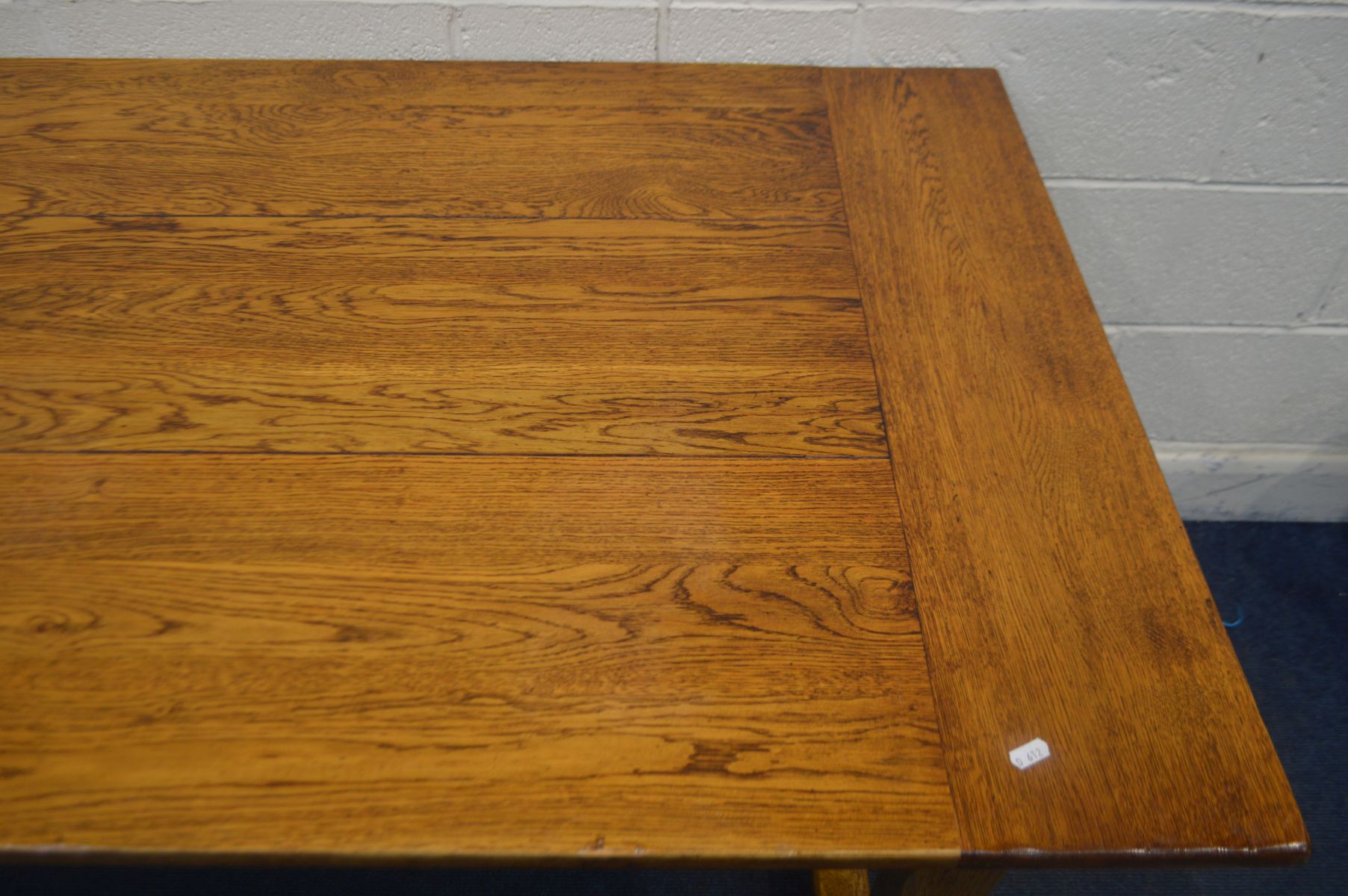 A REPRODUCTION OAK REFECTORY TABLE, in an 18th century style, plank top, on chamfered legs united by - Image 2 of 3
