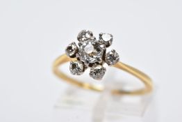 A YELLOW METAL DIAMOND CLUSTER RING, of a flower design, set with a central old cut diamond within
