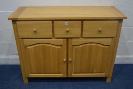 A SOLID LIGHT OAK SIDEBOARD, with three drawers, width 120cm x depth 45cm x height 90cm