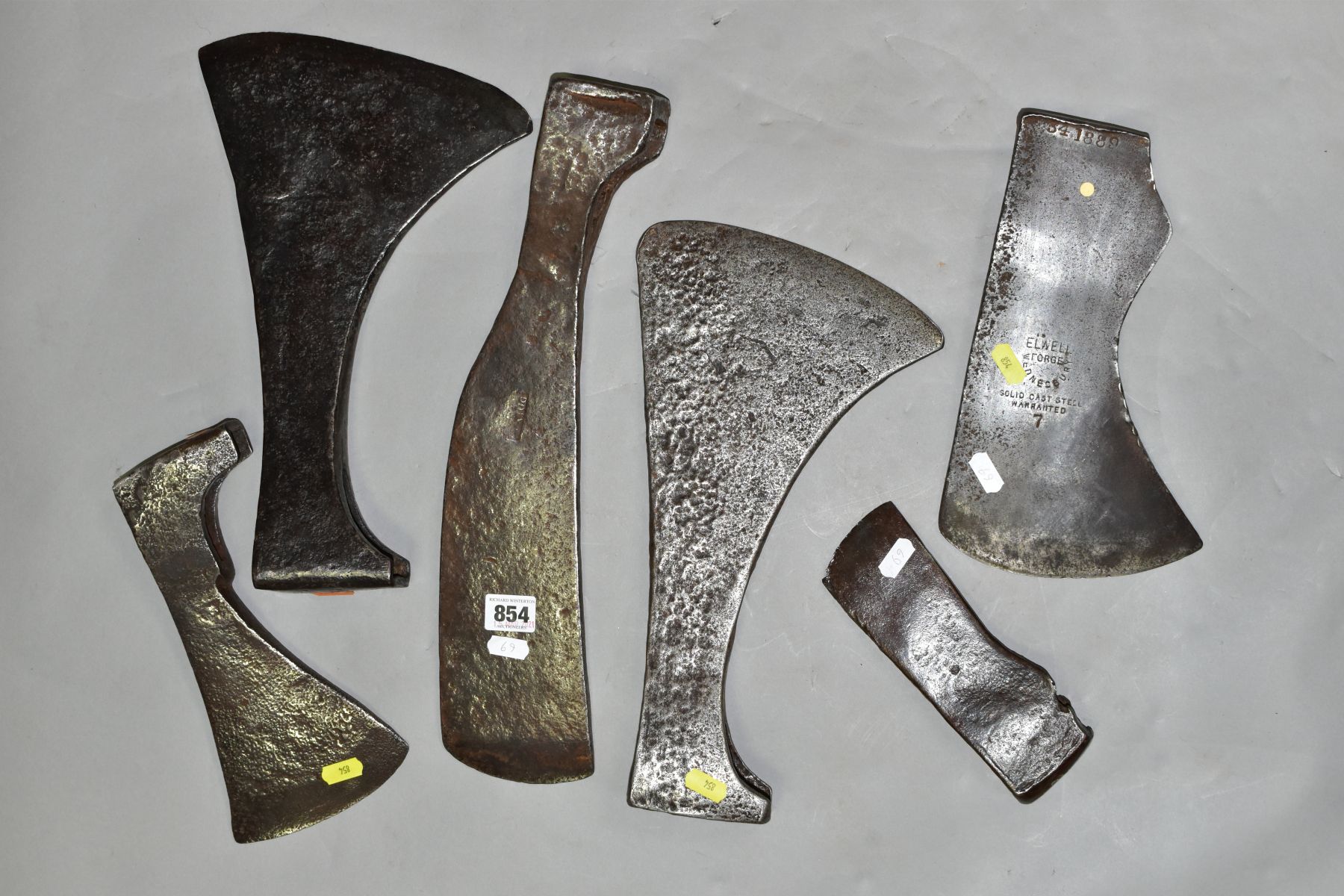 SIX VINTAGE AXE HEADS including an Elwell No 7 felling, a 9'' edge Trade 13½'' long, an 18th Century