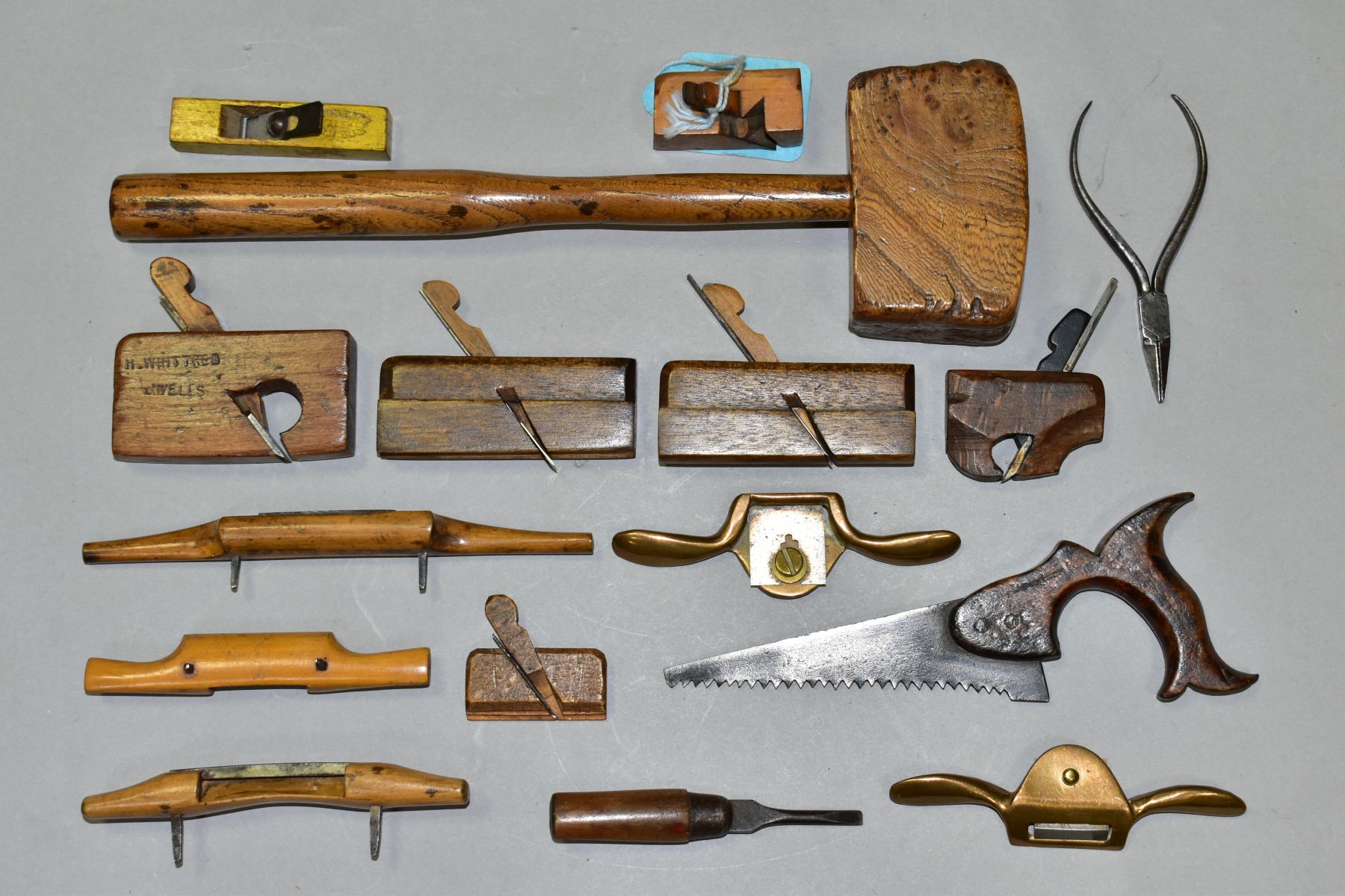 A SMALL TRAY CONTAINING MINIATURE CARPENTERS TOOLS including ½'' shoulder plane 2½'' long, a 1½''