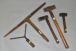 A BOX CONTAINING FIVE VINTAGE TOOLS, including a shipwrights maul with a 7'' head, a smithies stake,