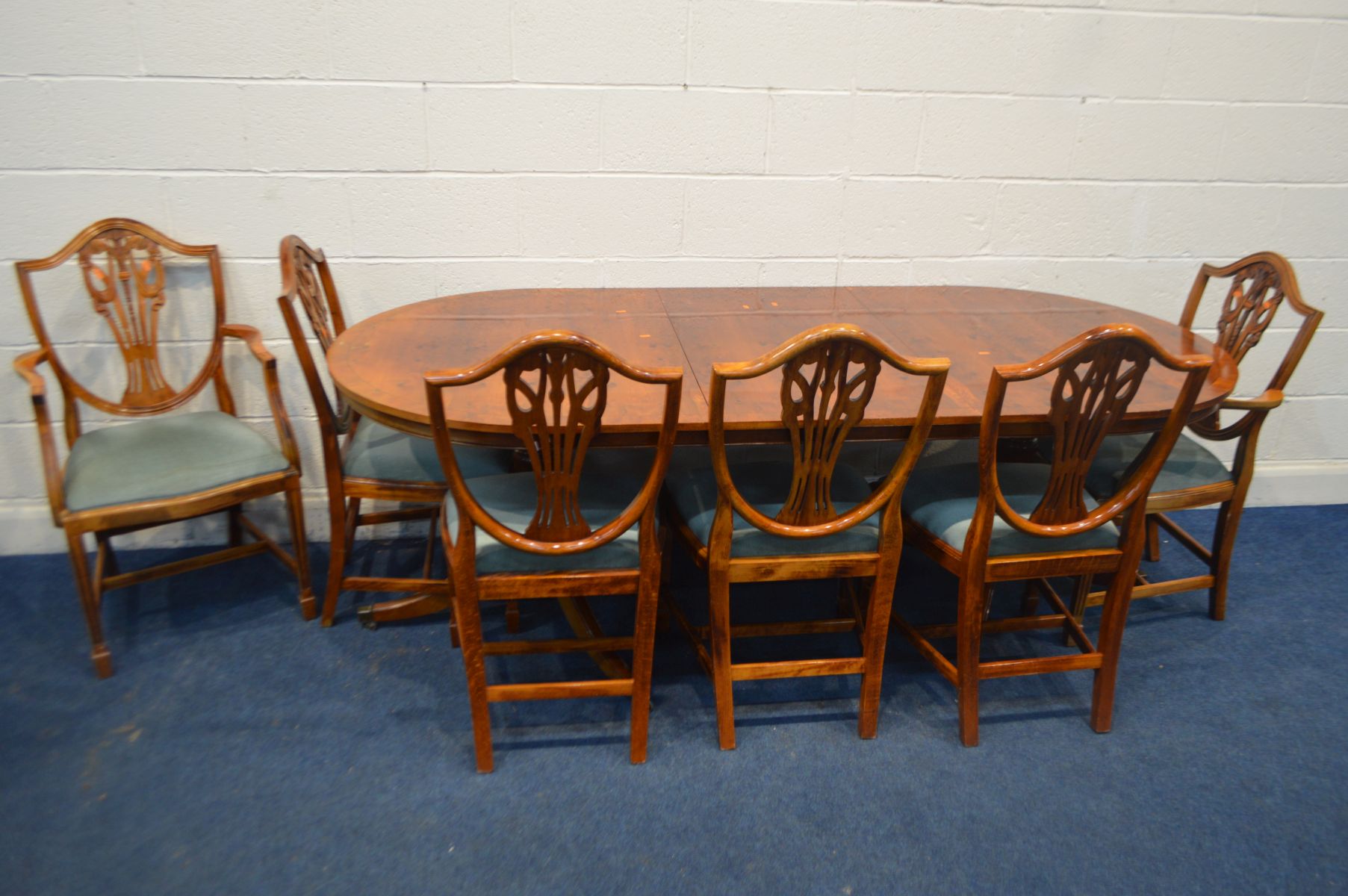 A MODERN YEWWOOD TWIN PEDESTAL DINING TABLE, with a single leaf, extended length 216cm x closed