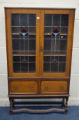 AN EARLY TO MID 20TH CENTURY OAK LEAD GLAZED ART NOUVEAU BOOKCASE, with two drawers on barley