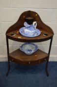 A GEORGIAN MAHOGANY CORNER WASHSTAND with a single drawer, with three matched blue and white jug and