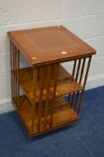 A BURR WALNUT AND OAK TWO TIER REVOLVING BOOKCASE, with a brown leather top, 49cm squared x height