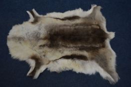 AN ANIMAL FUR RUG, 130cm x 114cm