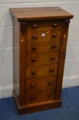 A VICTORIAN WALNUT WELLINGTON CHEST OF SEVEN GRADUATED DRAWERS, locked by a hinged locking bar,