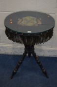 A LATE VICTORIAN EBONISED GYPSY TABLE, with a needlework crest of Magdalen College, Cambridge,