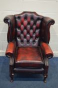 AN OXBLOOD LEATHER BUTTONED WING BACK ARMCHAIR, on mahogany cabriole front legs (no tears and