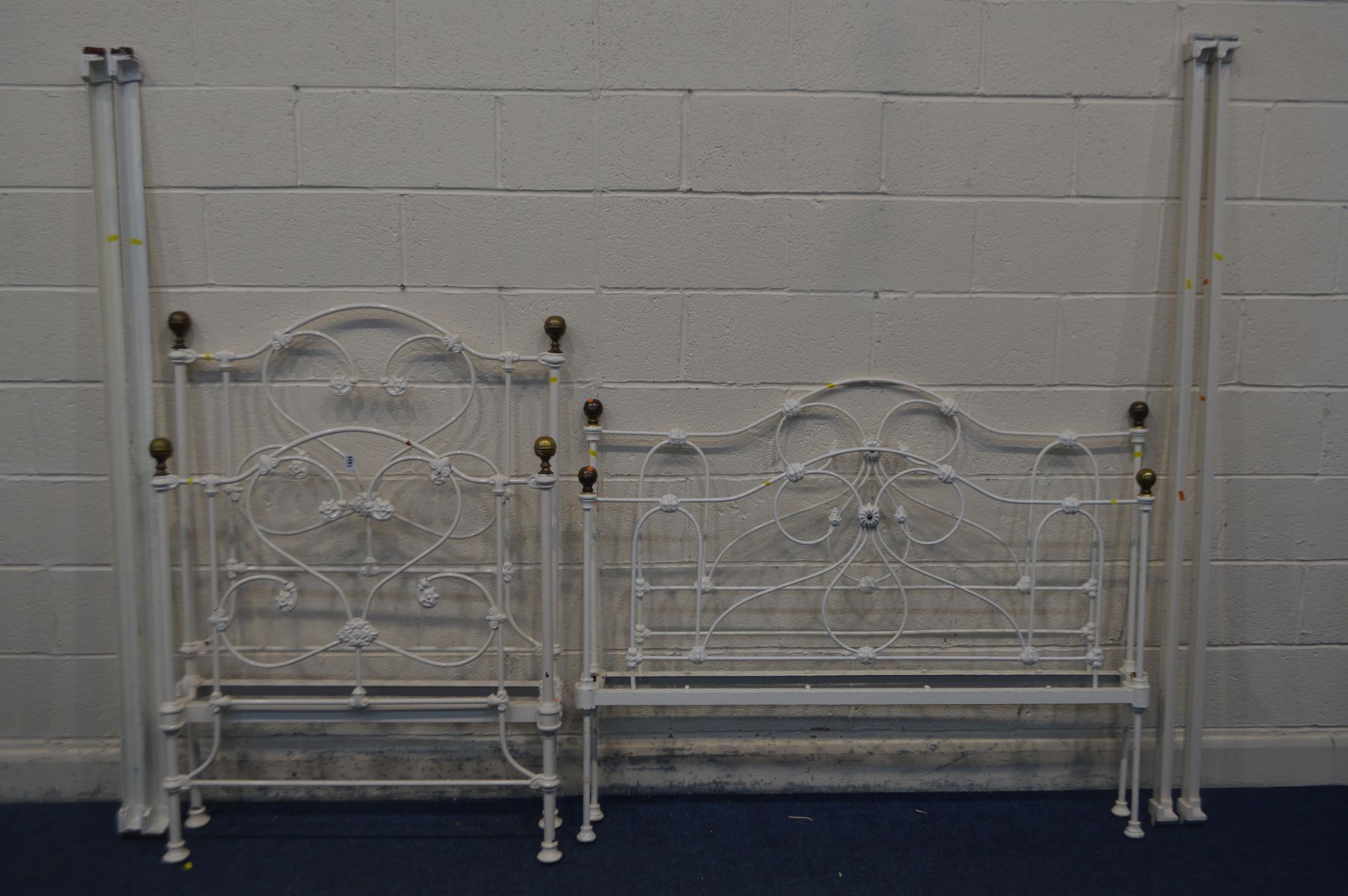 A PAINTED CAST IRON VICTORIAN STYLE 4FT6 BEDSTEAD with irons, and a similar single bedstead with