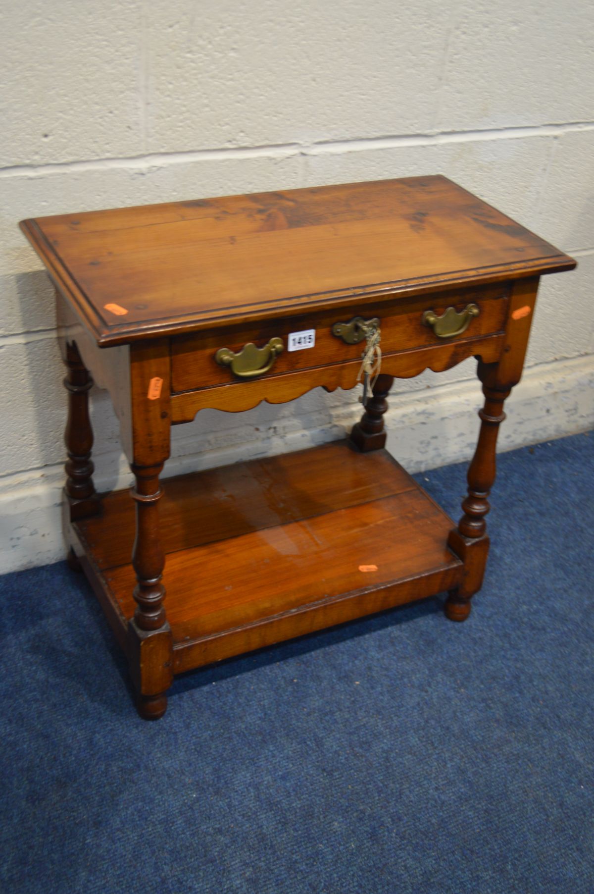 A REPRODUCTION CHERRYWOOD LAMP TABLE with a single drawer, on a joint base with turned supports