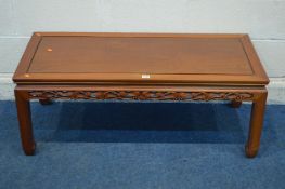 AN ORIENTAL HARDWOOD COFFEE TABLE with a carved frieze, length 112cm x depth 51cm x height 44cm