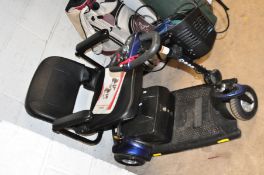 A PRIDE GO GO TRAVELLER DISABLILTY SCOOTER with one key, charger and cover (some damage to