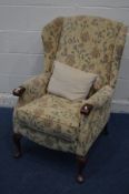 A MAHOGANY FRAMED AND FLORAL UPHOLSTERED WING BACK ARMCHAIR