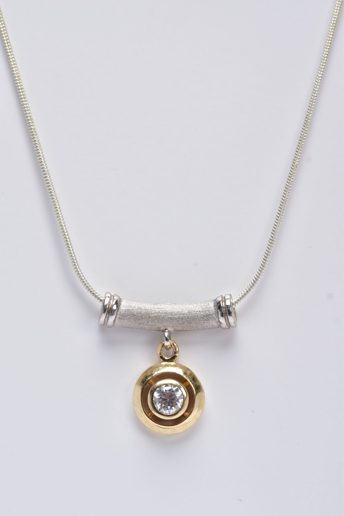 A TWO-TONE PENDANT ON A WHITE METAL CHAIN, the pendant designed with an openwork, circular yellow - Image 2 of 2