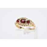 AN EARLY 20TH CENTURY 18CT GOLD BOAT RING, designed with a central oval cut garnet, within a