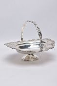 A SILVER BASKET, of an oval form, decorative scroll and foliate wavy rim and handle, raised on an