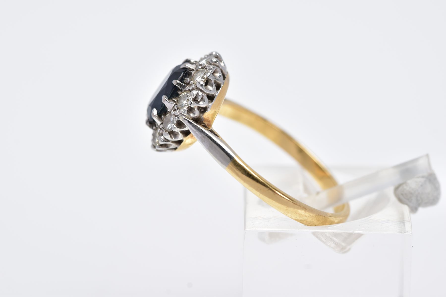 A YELLOW METAL SAPPHIRE AND DIAMOND CLUSTER RING, designed with an oval cut claw set blue sapphire - Image 2 of 3