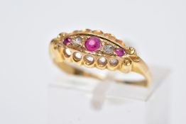 AN EARLY 20TH CENTURY 18CT GOLD BOAT RING, designed with three graduated, circular cut rubies