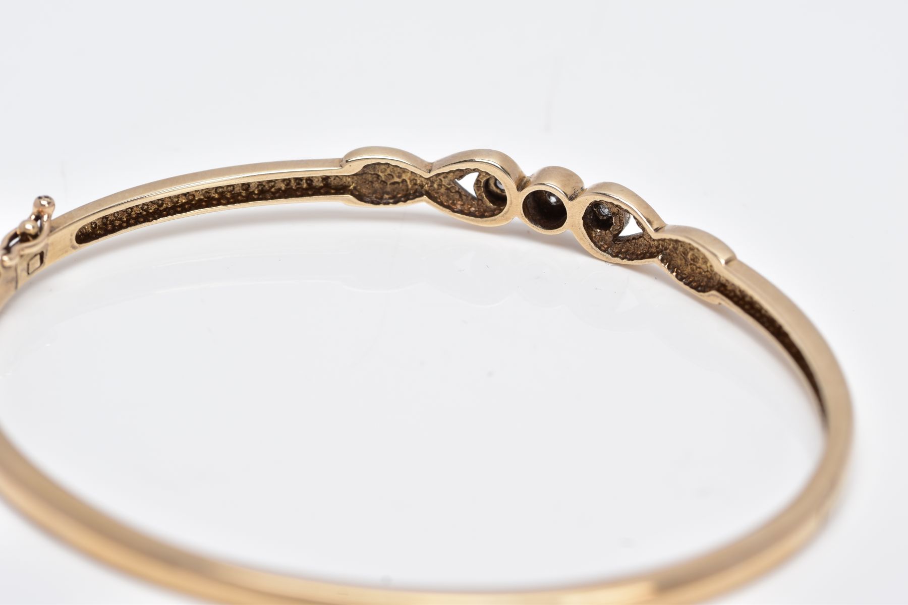 A 9CT GOLD DIAMOND BANGLE, designed with a crossover section set with three round brilliant cut - Image 3 of 5