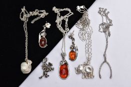 FOUR WHITE METAL PENDANT NECKLACES, A PAIR OF AMBER EARRINGS AND A CHARM, to include an amber