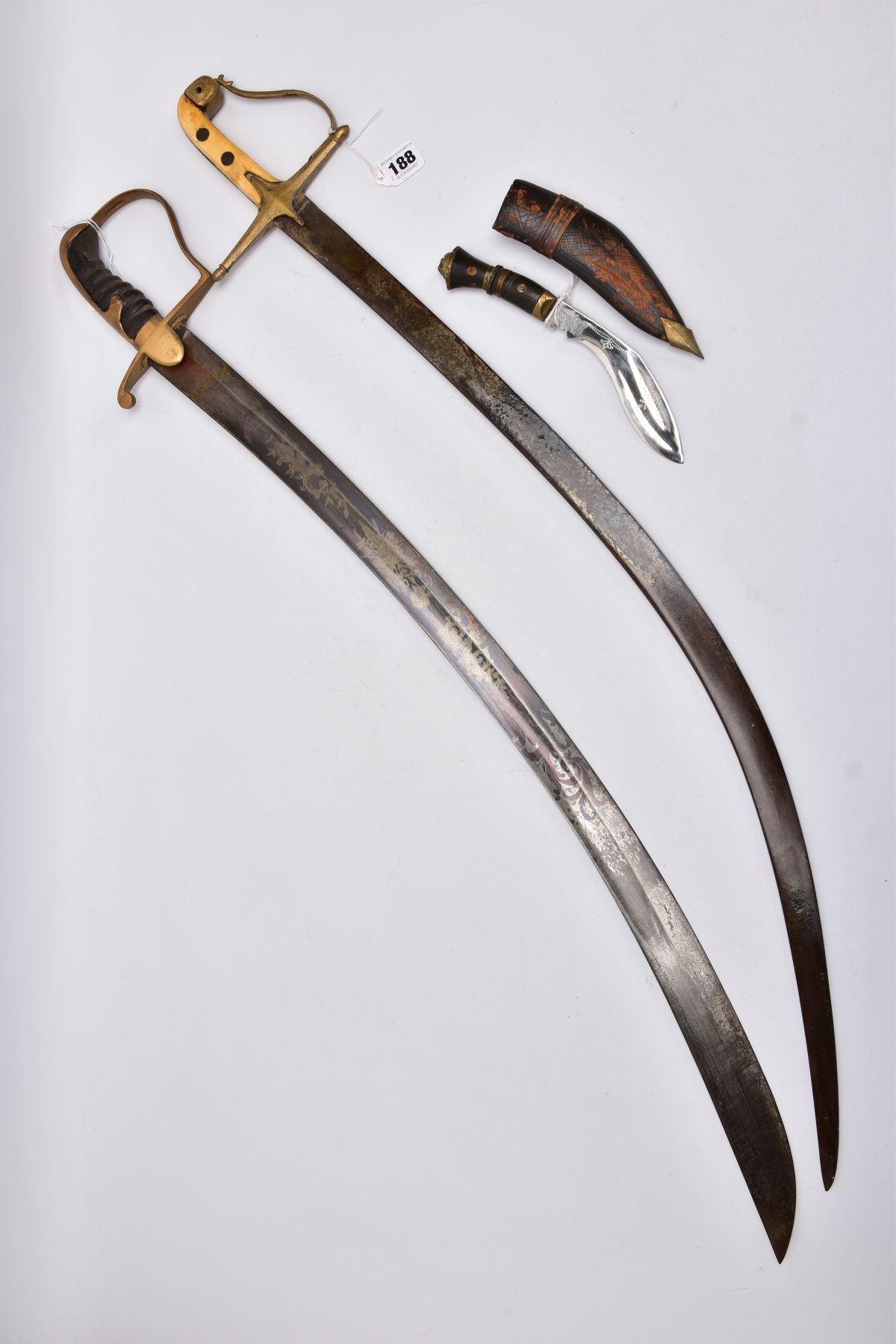 TWO LONG CURVED BLADE SWORDS, Eastern in design and looks, blade on one has been lacquered, etched